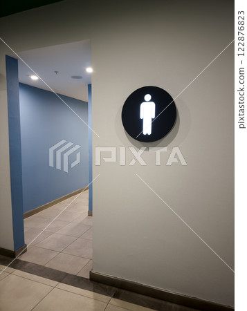 Entrance to public toilet with sign on wall indicating male gender Entrance to public toilet with sign on wall indicating male gender 122876823