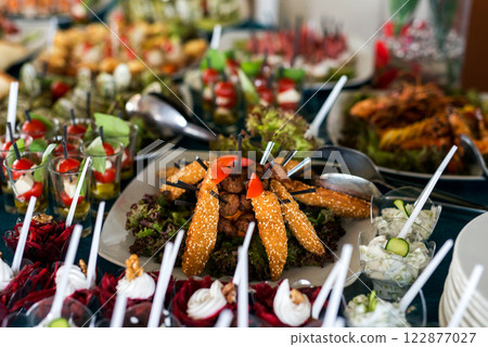 Snacks for the holiday, catering. Various snacks. Assortment of salads and buffet dishes. Meat, fish, cheese, salads, fruits and vegetables, sauces and canapes for celebrating a festive event. Snacks for the holiday, catering. Various snacks. Assortment of salads and buffet dishes. Meat, fish, cheese, salads, fruits and vegetables, sauces and canapes for celebrating a festive event. 122877027
