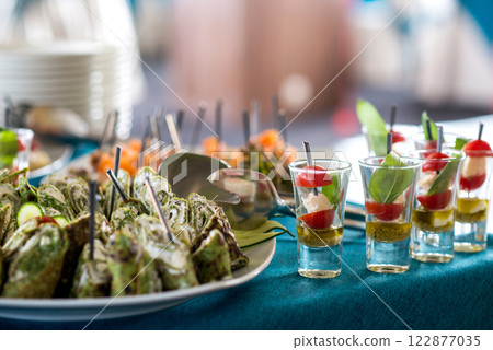 Snacks for the holiday, catering. Various snacks. Assortment of salads and buffet dishes. Meat, fish, cheese, salads, fruits and vegetables, sauces and canapes for celebrating a festive event. Snacks for the holiday, catering. Various snacks. Assortment of salads and buffet dishes. Meat, fish, cheese, salads, fruits and vegetables, sauces and canapes for celebrating a festive event. 122877035