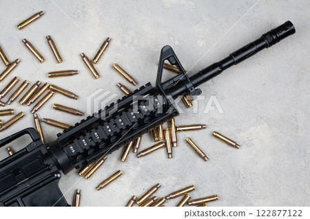 M4 carbine and 5.56mm shells and magazine with bullets M4 carbine and 5.56mm shells and magazine with bullets 122877122