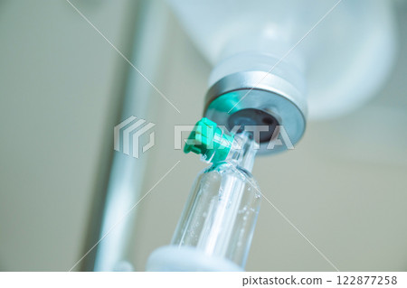 Close up medical intravenous IV drip in hospital background Close up medical intravenous IV drip in hospital background 122877258