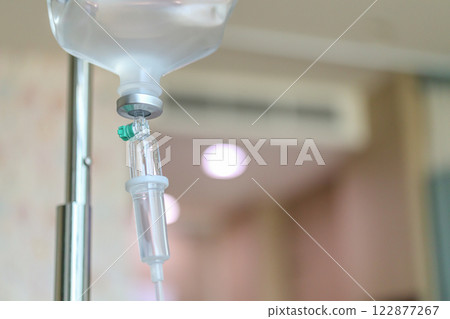 Close up medical intravenous IV drip in hospital background 122877267