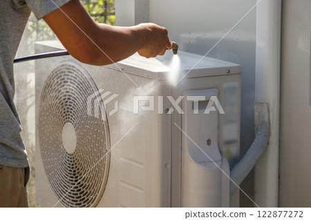 air conditioning compressor outdoor unit cleaning service with water spray 122877272