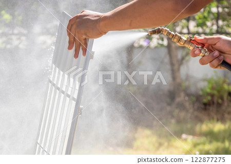 air conditioning filter cleaning with water spray air conditioning filter cleaning with water spray 122877275