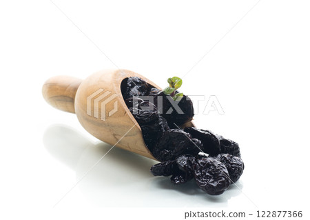 Wooden spoon with prunes, isolated on a white background 122877366
