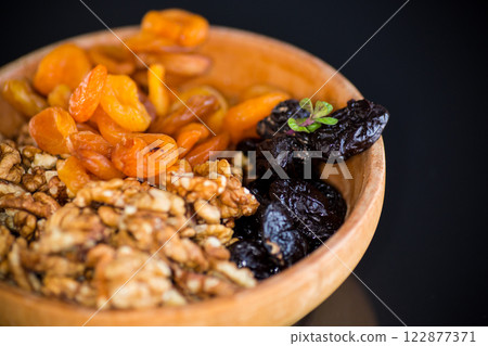 Natural dried Prunes, dried apricots and nuts close-up in macro photography 122877371