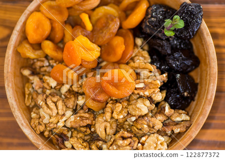 Natural dried Prunes, dried apricots and nuts close-up in macro photography 122877372