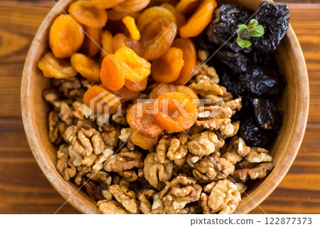 Natural dried Prunes, dried apricots and nuts close-up in macro photography Natural dried Prunes, dried apricots and nuts close-up in macro photography 122877373