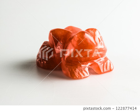 Carnelian frog bringing good luck on a white background. Close-up. 122877414