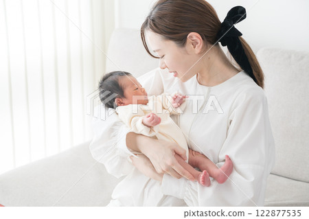 Baby hugged in Mama 122877535