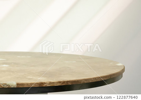 Round marble table top with abstract shadow drop on white wall background for mockup product display 122877640