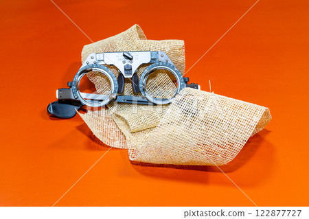 optical device for vision testing on a brown cloth with a orange surface optical device for vision testing on a brown cloth with a orange surface 122877727