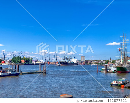 Hamburg harbor panorama with cargo ships, cranes, and historic sailing vessel . High quality photo 122877821