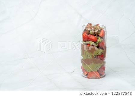 Popular Dubai chocolate strawberry cup with kataifi, pistachio paste, tahini, milk chocolate and fresh strawberries. Desserts and sweets.Copy space for text. 122877848