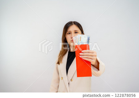 Taiwanese girl holding red envelope with money, Chinese New Year red packet with cash, bonus and salary concept - financial success and wealth Taiwanese girl holding red envelope with money, Chinese New Year red packet with cash, bonus and salary concept - financial success and wealth 122878056