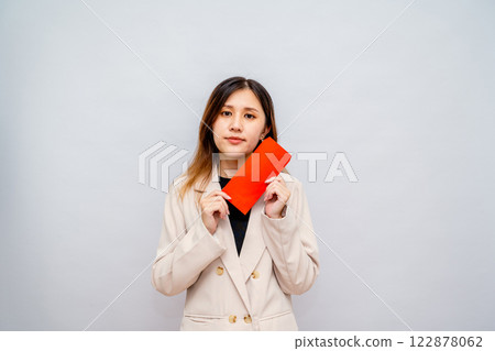 Woman holding red envelope with money, Chinese New Year red packet with cash, bonus and salary concept - financial success and wealth 122878062