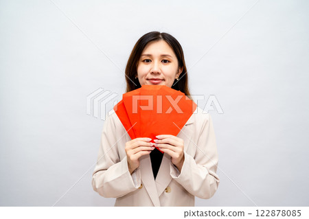 Woman holding money red envelope, Chinese New Year red packet, cash, bonus and salary concept - financial success and wealth Woman holding money red envelope, Chinese New Year red packet, cash, bonus and salary concept - financial success and wealth 122878085