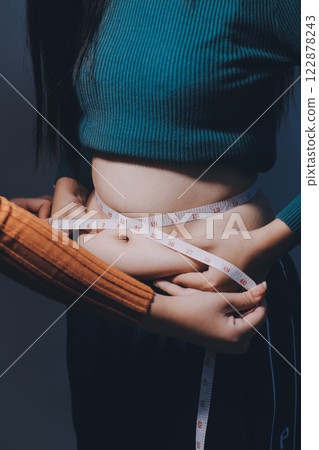 Asian Woman Pinching Her Belly Fat With Left Hand Asian Woman Pinching Her Belly Fat With Left Hand 122878243