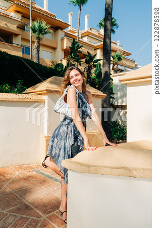 Effortless summer elegance: chic fashion meets luxury architecture in a vibrant Mediterranean Effortless summer elegance: chic fashion meets luxury architecture in a vibrant Mediterranean 122878598