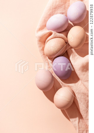 Easter background with colorful pastel eggs on linen napkin. Trendy Easter card in minimalistic style with copy space. Easter background with colorful pastel eggs on linen napkin. Trendy Easter card in minimalistic style with copy space. 122879938