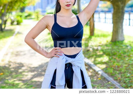 A cool woman jogging on a road with sunlight filtering through the trees Walking Diet Exercise Exercise Trimming A cool woman jogging on a road with sunlight filtering through the trees Walking Diet Exercise Exercise Trimming 122880021