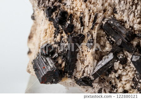 Macro mineral stone Schorl, Black Tourmaline on the feldspar on a white background 122880121
