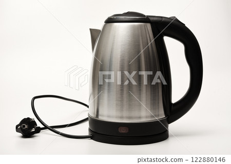 Electric kettle on a white background. A metal teapot with a black handle. Electric kettle on a white background. A metal teapot with a black handle. 122880146