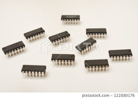 A microcontroller on a white background. An electronic chip in a plastic case. A microcontroller on a white background. An electronic chip in a plastic case. 122880176