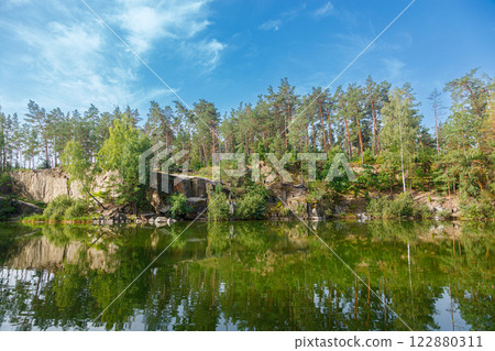 beautiful lake with a canyon on which swans swim with a blue sky beautiful lake with a canyon on which swans swim with a blue sky 122880311