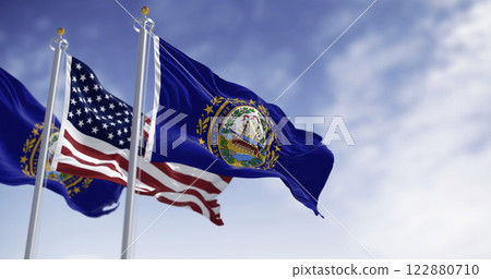New Hampshire and National US flags waving in the wind on a clear day New Hampshire and National US flags waving in the wind on a clear day 122880710