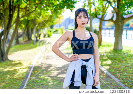 A cool woman jogging on a road with sunlight filtering through the trees Walking Diet Exercise Exercise A cool woman jogging on a road with sunlight filtering through the trees Walking Diet Exercise Exercise 122880818