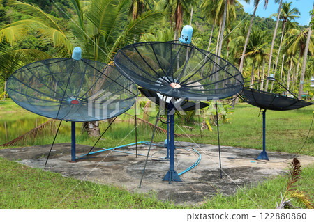 Satellite dishes in wood amongst palm trees on the Koh-Chang island in Thailand Satellite dishes in wood amongst palm trees on the Koh-Chang island in Thailand 122880860