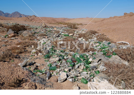 Broken bottles glass lies in desert, abuse of environment Broken bottles glass lies in desert, abuse of environment 122880884