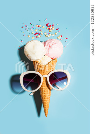 Ice cream cone with sugar sprinkles and sun glasses Ice cream cone with sugar sprinkles and sun glasses 122880952