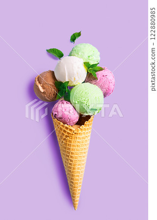 Ice cream scoops in waffle cone 122880985