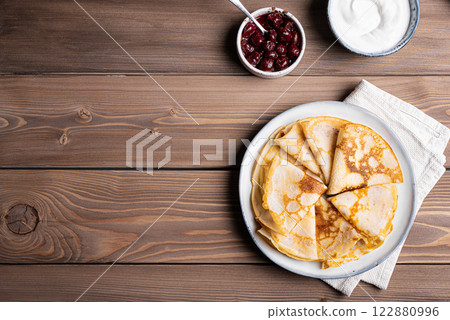 Homemade crepes pancakes with sour cream and cherry jam Homemade crepes pancakes with sour cream and cherry jam 122880996