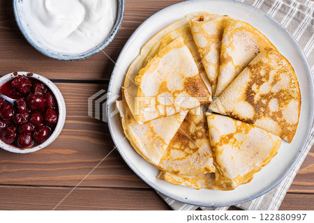 Homemade crepes pancakes with greek yogurt and cherry syrup Homemade crepes pancakes with greek yogurt and cherry syrup 122880997