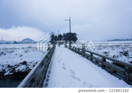A sacred forest on the other side of a snow-covered bridge A sacred forest on the other side of a snow-covered bridge 122881182