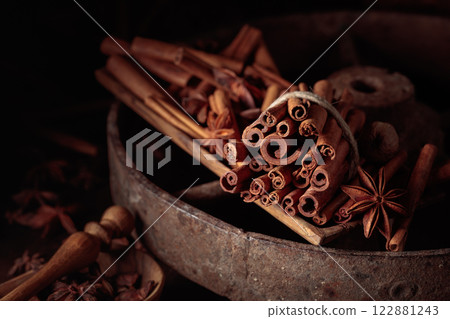 Cinnamon sticks, anise, and nutmeg on a wooden table. 122881243