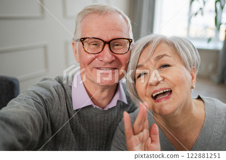 Happy senior woman man talk on video call with friends family. Mature old grandmother grandfather talking speaking with grown up children online. Older generation modern tech usage. Webcamera view Happy senior woman man talk on video call with friends family. Mature old grandmother grandfather talking speaking with grown up children online. Older generation modern tech usage. Webcamera view 122881251