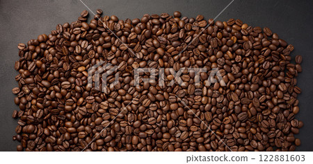 Scattered roasted coffee beans on black background, top view 122881603