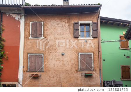 Colorfull houses in a street of the Malcesine, town on the shore of Lake Garda, Italy, Europe. 122881723