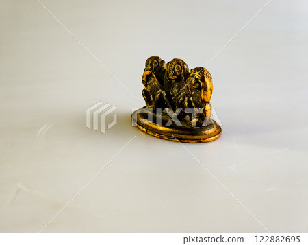 Souvenir figurines of the three monkeys, symbolizing the Buddhist idea of non-doing of evil, detachment from false - see nothing, hear nothing, say nothing 122882695