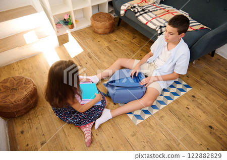 Children studying together on the floor 122882829