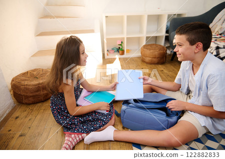 Two children studying at home Two children studying at home 122882833