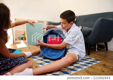 Children organizing school supplies together Children organizing school supplies together 122882843