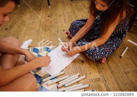 Children Drawing Together on Paper 122882869
