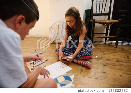 Children Drawing Together on Wooden Floor 122882882