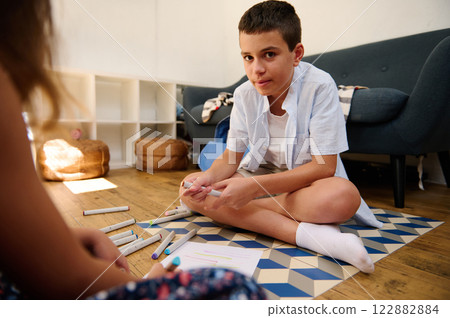Young boy drawing at home Young boy drawing at home 122882884