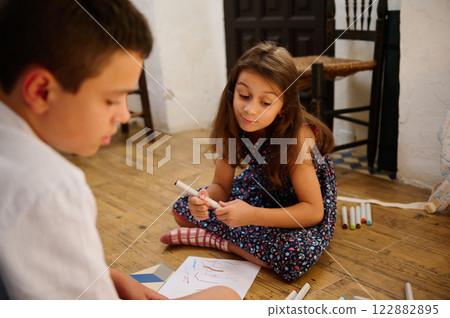 Children Drawing Together on the Floor 122882895